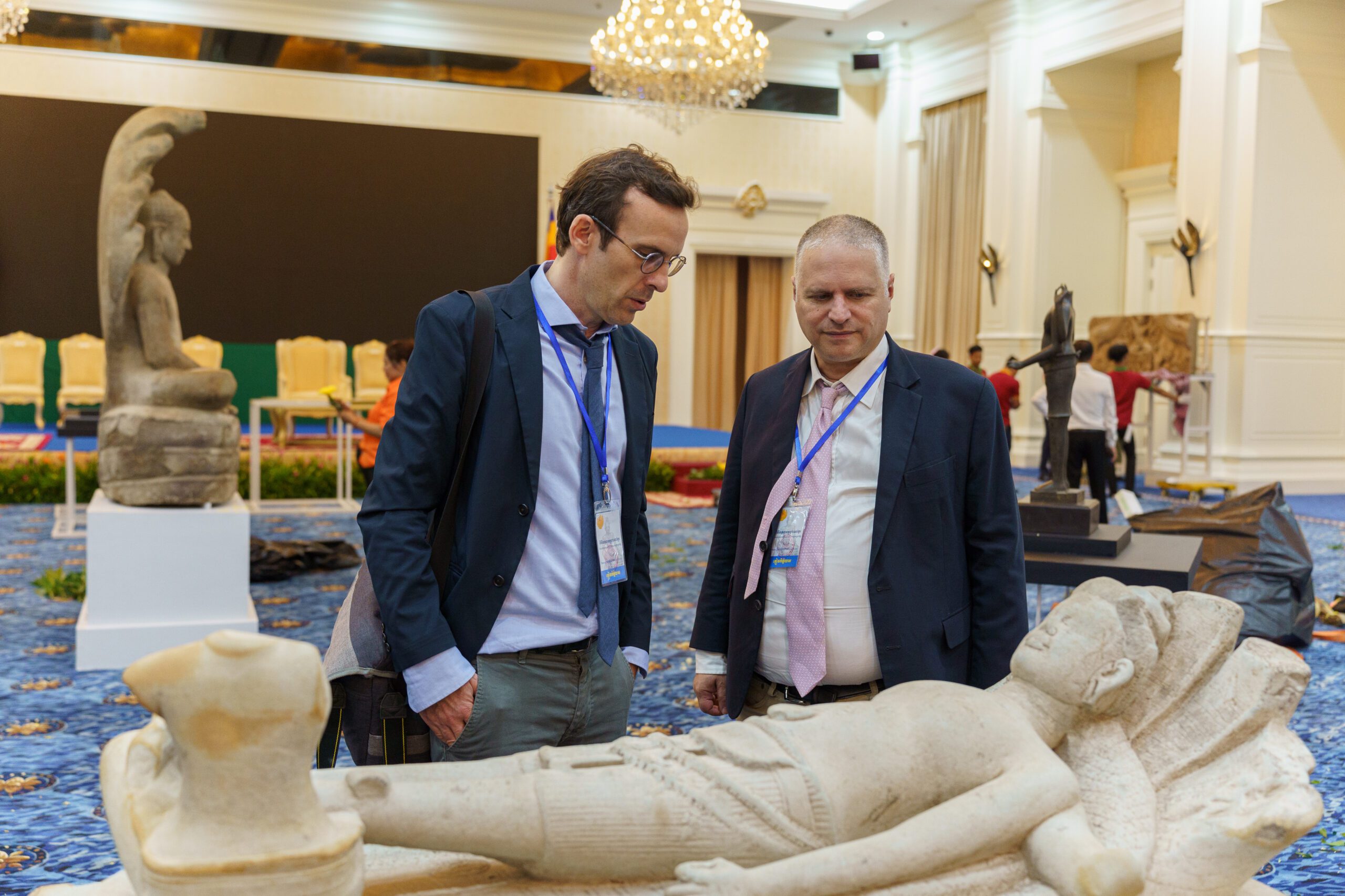 August 22, 2024 - Phnom Penh (Cambodia). Eric Bourdonneau from Ecole française d'Extrême-Orient and Brad Gordon - attorney for the Cambodian Ministry of Culture and Fine Arts - check the statue of Vishnu Anantasayin, one of the 70 stolen Khmer artifacts on display during a ceremony at the Peace Palace in Phnom Penh, marking the return of these precious items from museums and private collectors abroad.